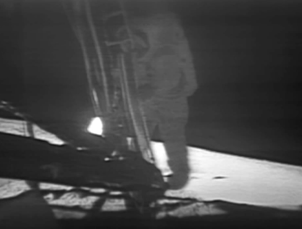 Armstrong taking his first step onto the surface of the moon.